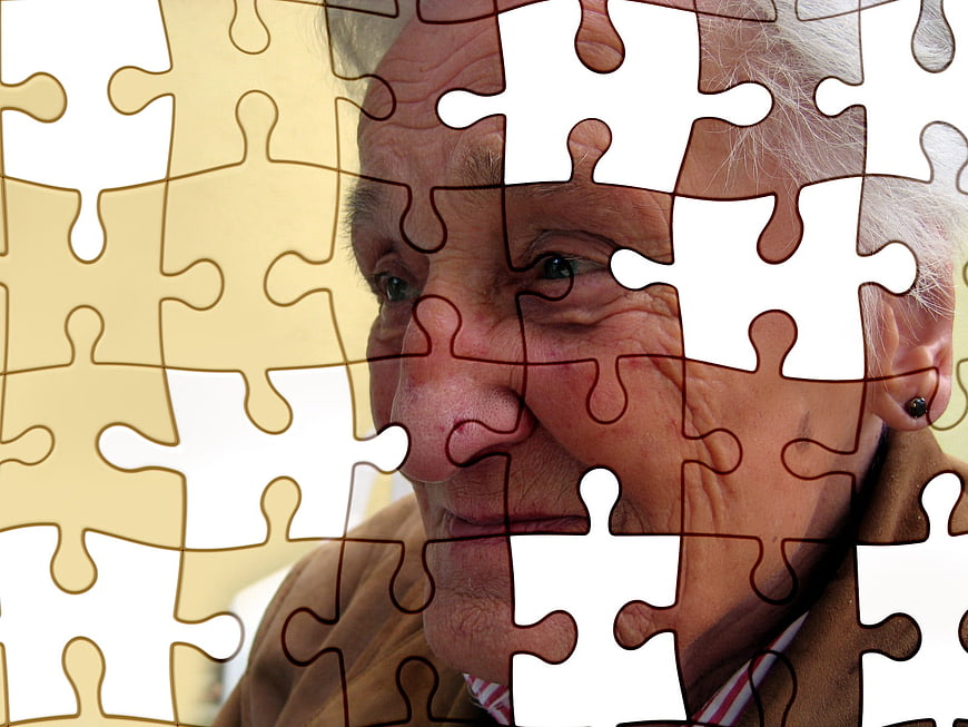 Senior woman face with missing puzzle pieces concept