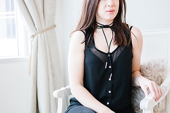 Woman in Black Choker Top Sitting in White Chair