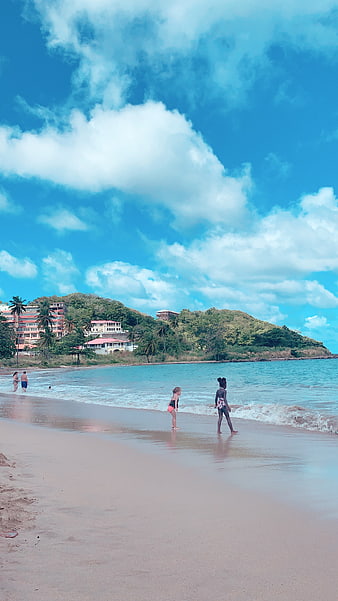 Tropical Beach Vacation with Kids Playing in Ocean Waves