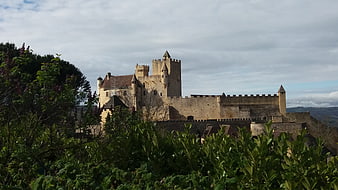 Medieval Castle in Perigord, France with Green Foliage