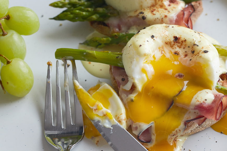 Close-up of Eggs Benedict with Runny Yolk and Asparagus