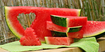 Sliced Watermelon With Heart Cutout On Green Cloth