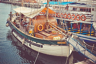 Classic Wooden Sailing Boat Docked in Harbor
