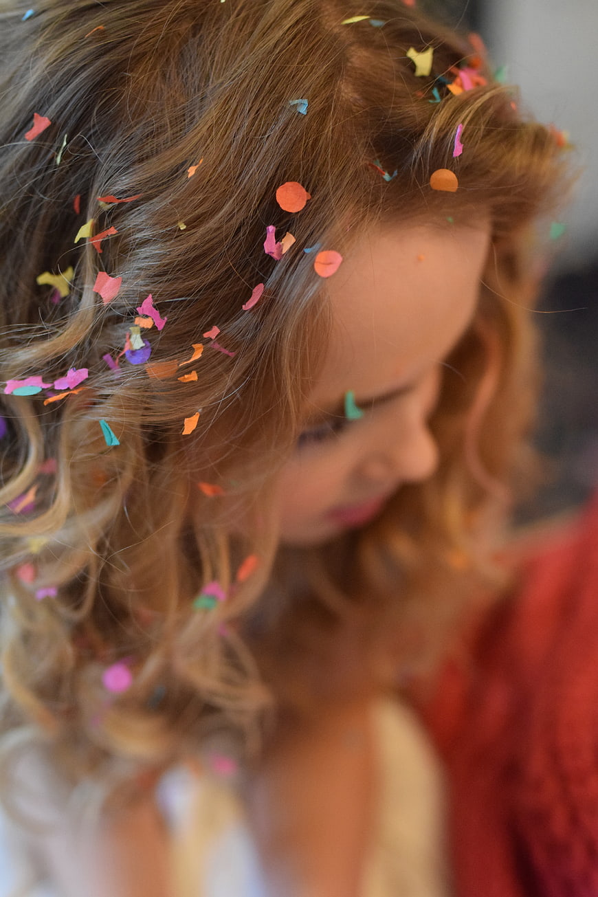 Close-up of Girl with Colorful Confetti in Hair