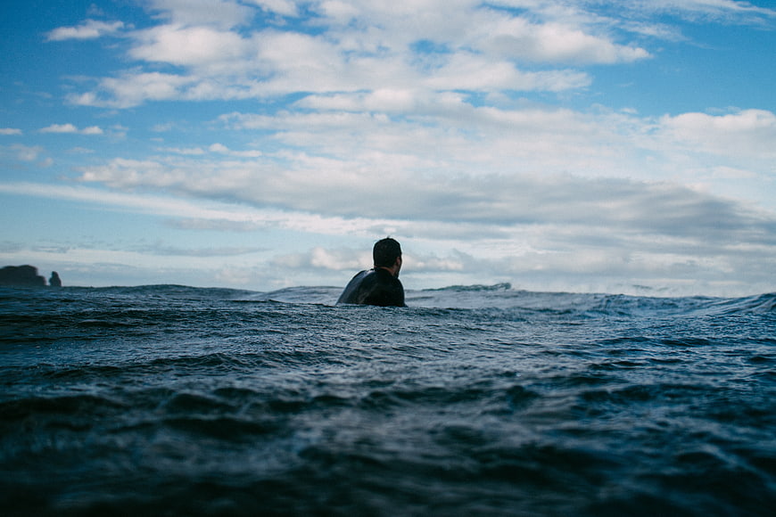 Surfer in Ocean Water Looking at Horizon