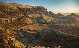 Winding Road Through Dramatic Highland Landscape at Sunset