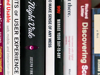 Close-up of book spines on a shelf with selective focus