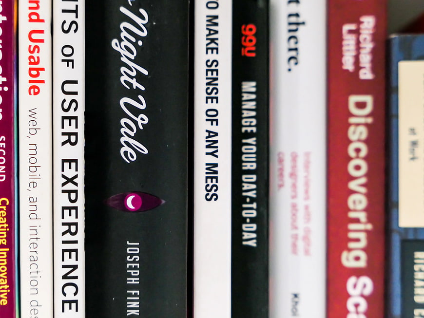 Close-up of book spines on a shelf with selective focus