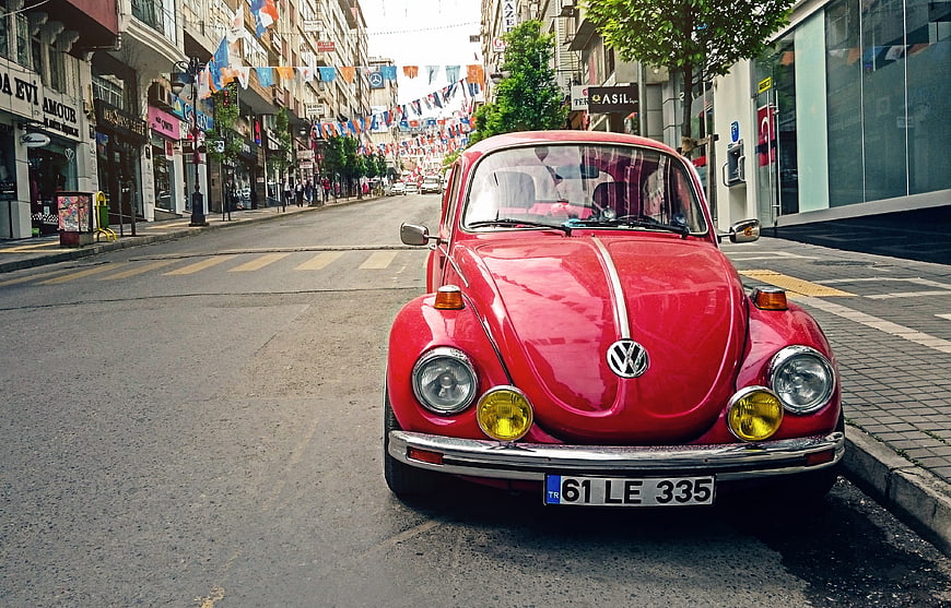 Red Classic Volkswagen Beetle Parked on City Street