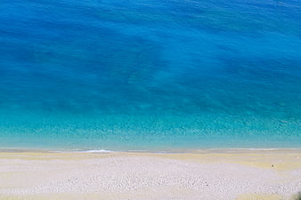 Aerial View of Turquoise Sea and White Sand Beach in Greece