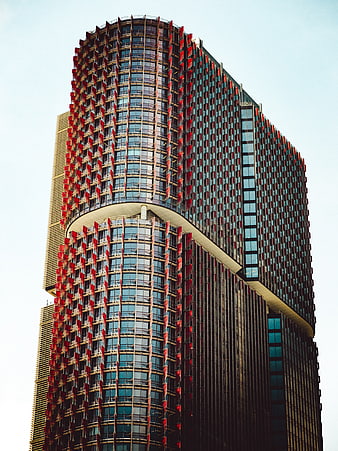 Modern skyscraper with red and blue glass facade