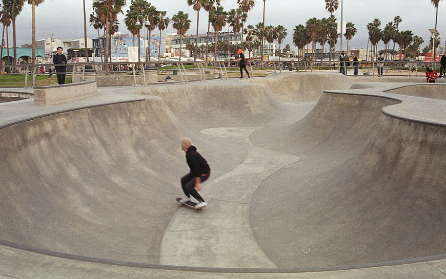 Skateboarder in Concrete Bowl at Venice Beach Skatepark