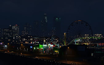 Night view of Santa Monica Pier and Los Angeles skyline