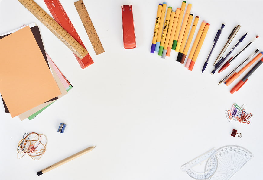 Flat lay of colorful school supplies and stationery on white background