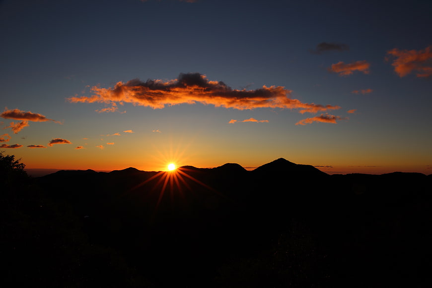 Sunset over Mountain Silhouette with Starburst Effect