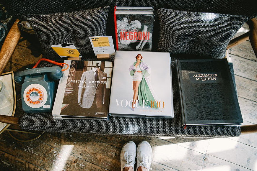 Fashion Books and Vintage Phone on Sofa