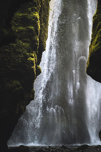 Mossy waterfall cascading through rocky crevice