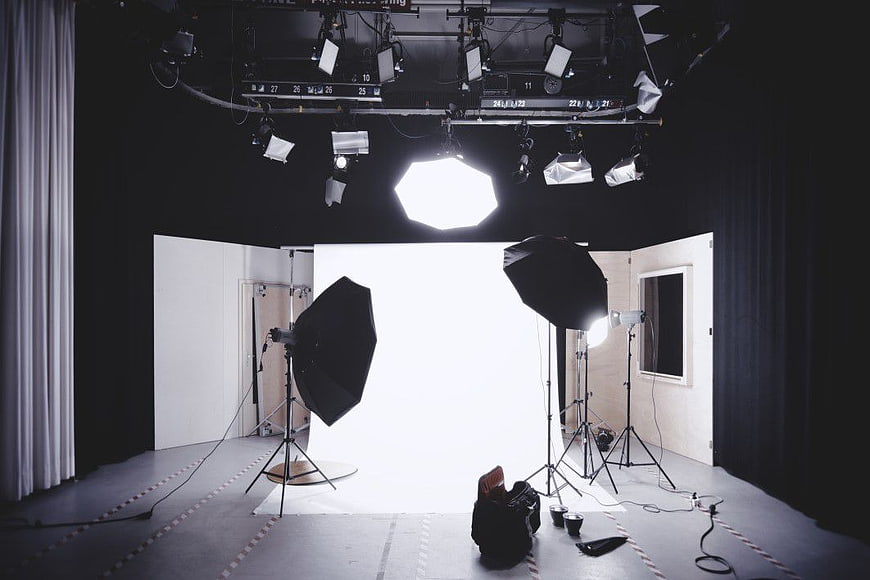 Professional photography studio setup with lighting equipment and white backdrop