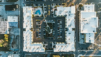 Aerial view of modern apartment complex with parking lot