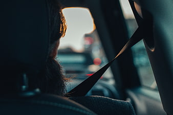 Woman Driving Car with Seatbelt at Sunset