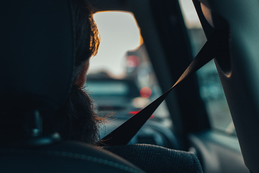 Woman Driving Car with Seatbelt at Sunset