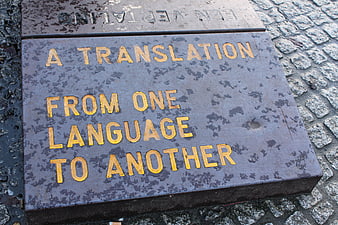 Close-up of a stone plaque with the text A Translation From One Language To Another