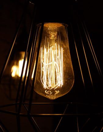 Glowing Edison Bulb in Geometric Black Cage Lamp