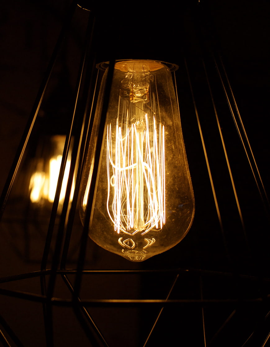Glowing Edison Bulb in Geometric Black Cage Lamp