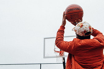 Man Shooting Basketball on Outdoor Court