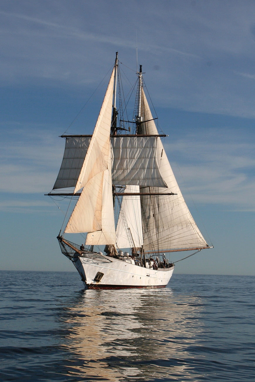 Classic Two-Masted Sailing Ship On Calm Blue Ocean