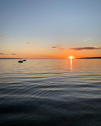 Serene Sunset Over Calm Ocean with Golden Reflection