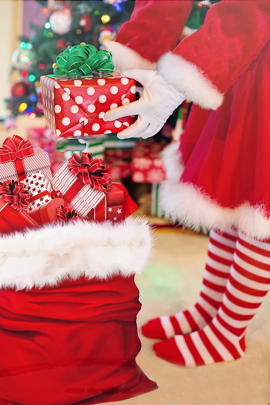 Santa Claus Placing Christmas Gifts Into Red Sack