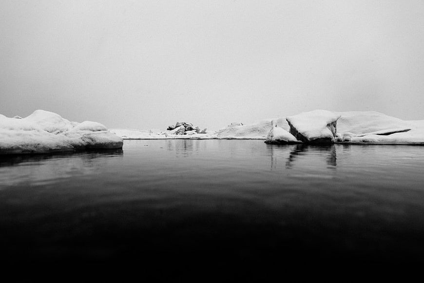 Black and White Winter Lake with Snowy Rocks