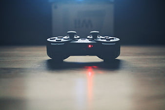 Gaming Controller on Wooden Table with Red Light
