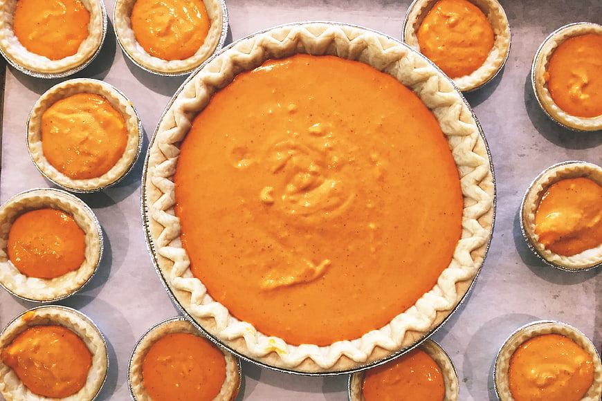 Top View of Unbaked Pumpkin Pie and Mini Pies