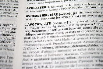 Close-up of French dictionary definition for Avocat lawyer