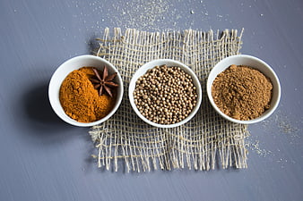 Top view of spices in white bowls on burlap
