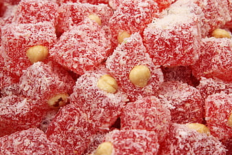 Close-up of red Turkish delight cubes with pistachios and coconut