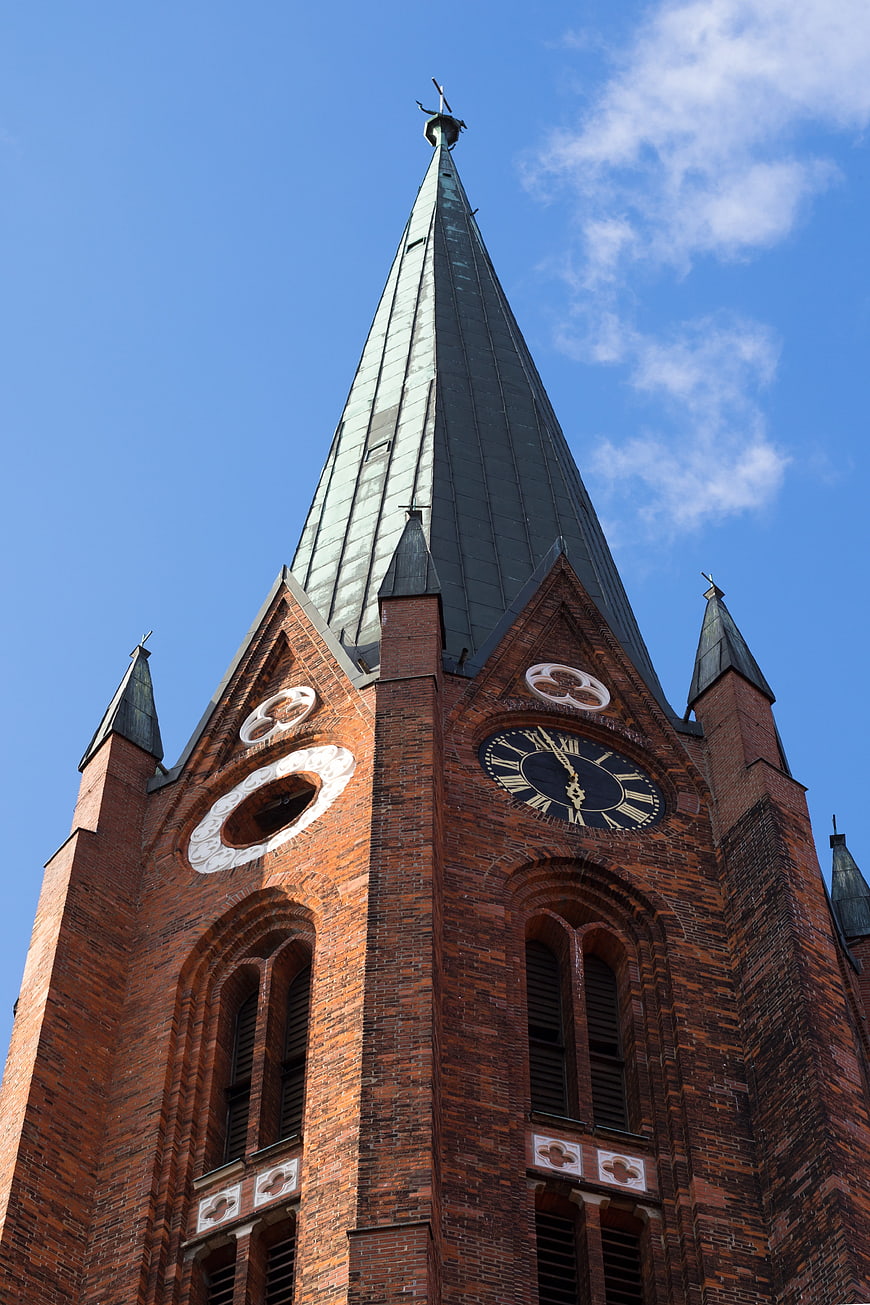 Low-Angle View of Historic Red Brick Church Tower with Clock