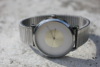 Minimalist Silver Watch on Concrete Surface