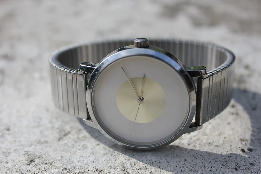 Minimalist Silver Watch on Concrete Surface