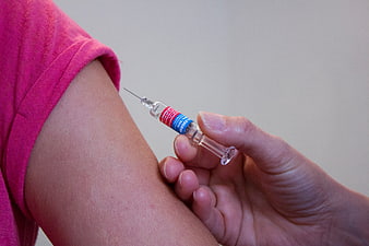 Close-up of vaccination injection in upper arm
