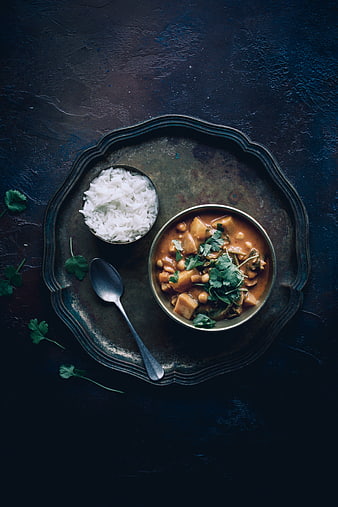 Top view of vegan chickpea curry and rice on dark tray