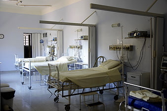 Empty hospital ward with medical beds and equipment