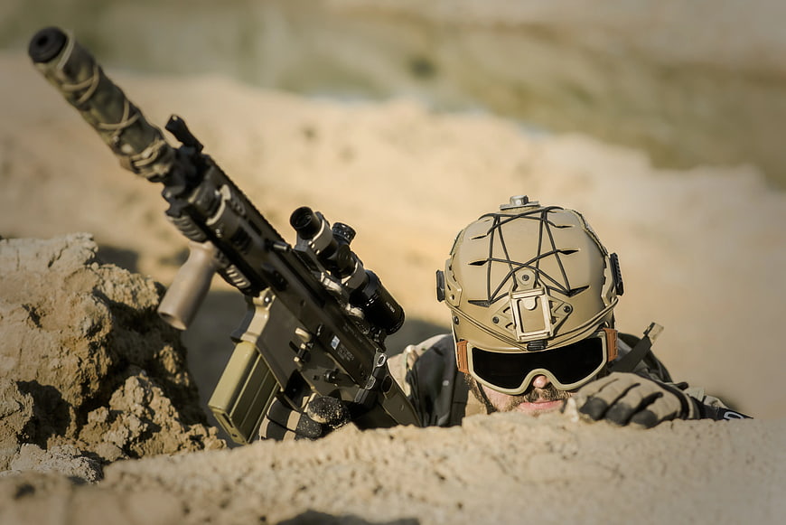 Soldier in Tactical Gear with Assault Rifle in Desert