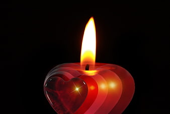 Red Heart Shaped Candle with Flame on Black Background