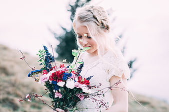 Young Blonde Woman Holding Colorful Wildflower Bouquet Outdoors