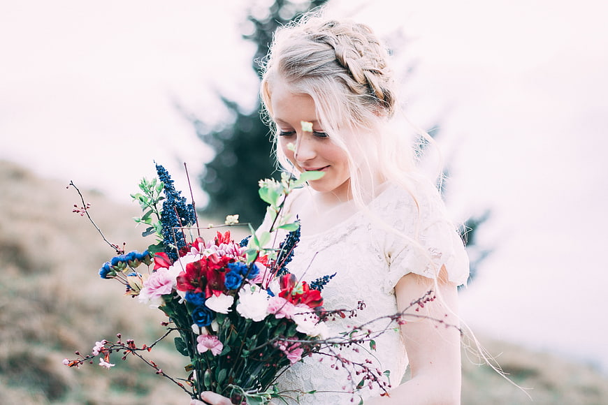 Young Blonde Woman Holding Colorful Wildflower Bouquet Outdoors