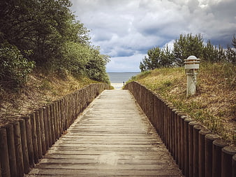 Wooden boardwalk path leading to the ocean beach