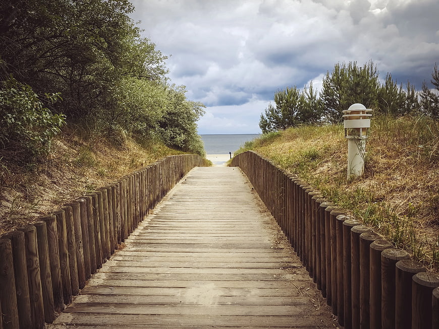 Wooden boardwalk path leading to the ocean beach